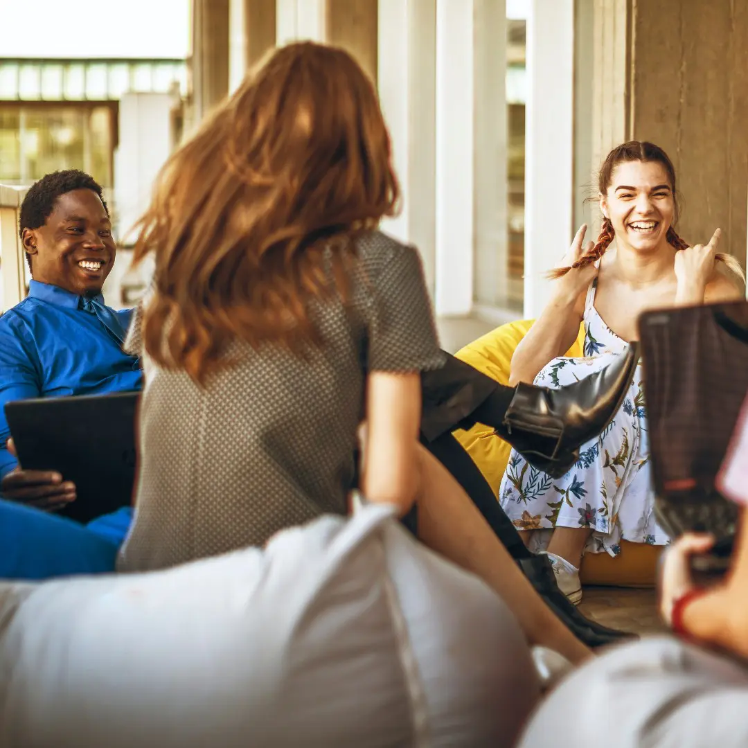 A group of people sitting around each other.